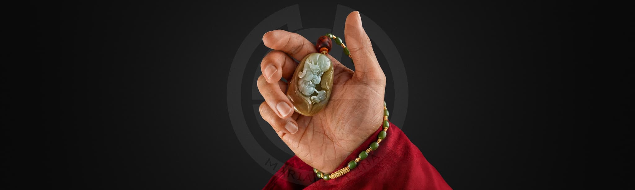 Yun Jin Luo jade amulet held in hand, carved Chinese talisman made of olive green jade