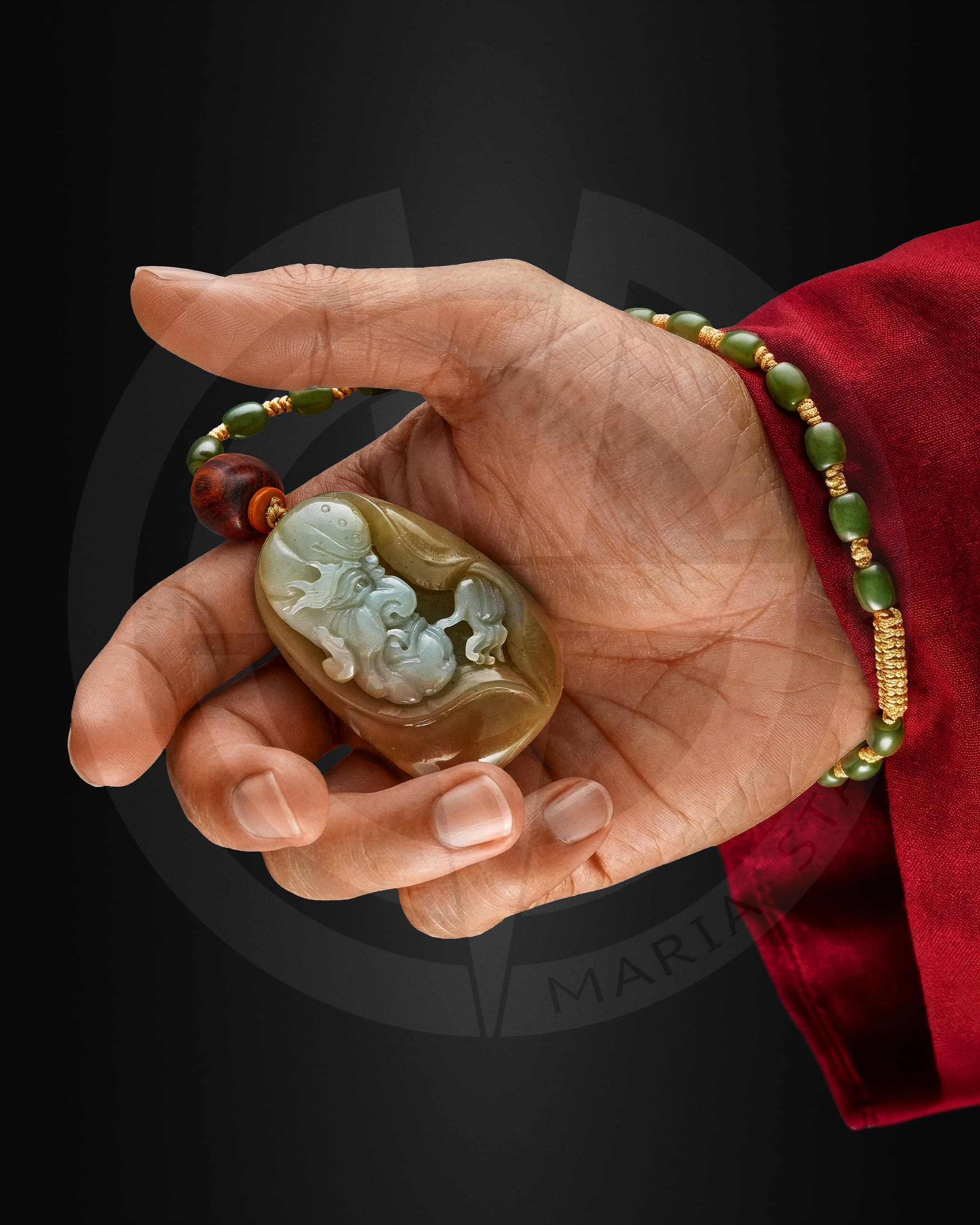 Yun Jin Luo jade amulet held in hand, carved Chinese talisman made of olive green jade