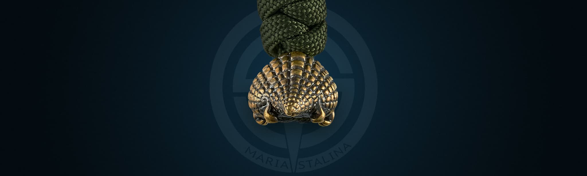 Crocodile Girl lanyard bead — bottom view, brass claws and legs
