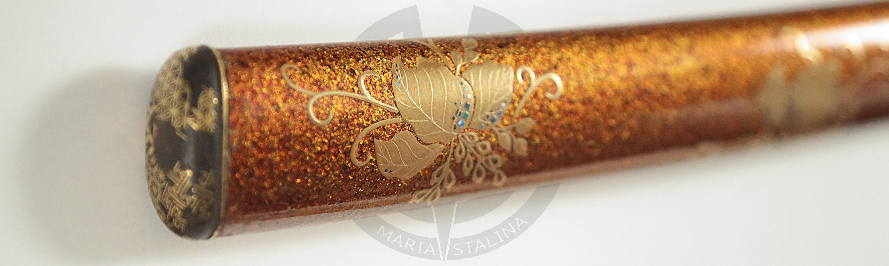 The scabbard is lacquered with golden crumbs