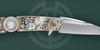 The warncliff blade of the collectible knife Kandiru Siska with mother-of-pearl